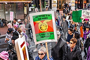 Jan 18, 2020 San Francisco / CA / USA - Participant to the Women`s March event holds climate change related sign while marching o