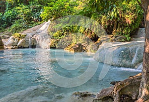 Jangle landscape with flowing turquoise water of Erawan photo