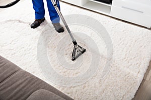 Janitor Cleaning Carpet With Vacuum Cleaner