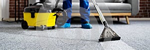 Janitor Cleaning Carpet With Vacuum Cleaner