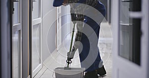 Janitor cleaning a corridor