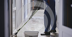 Janitor cleaning a corridor