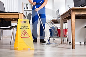 Janitor Cleaning Floor In Office photo