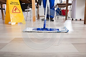 Janitor Cleaning Floor In Office