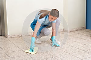 Janitor Cleaning Floor With Rag