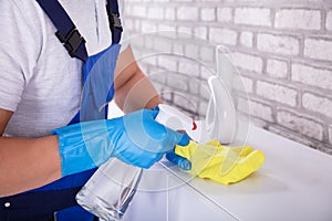 Janitor Cleaning Furniture With Cloth