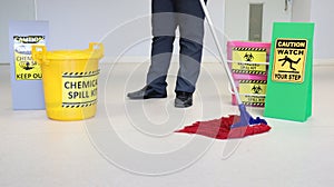 Janitor male cleaning floor in medical service room or laboratory with caution tag sign watch your step and Biohazard spill kit, c