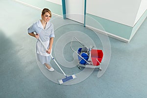 Janitor with mop and cleaning equipment