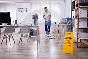 Janitor With Mop Cleaning Office photo