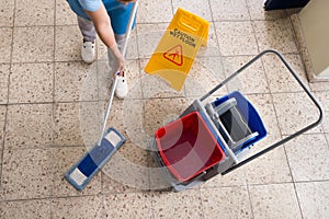 Janitor Mopping Floor With Cleaning Equipments