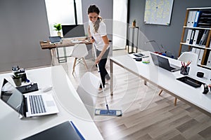 Janitor Mopping Floor In Office