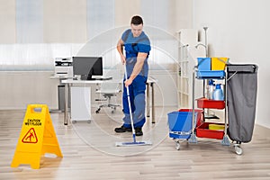 Janitor Mopping Floor In Office
