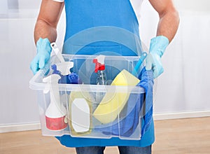 Janitor with a tub of cleaning supplies