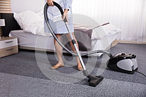 Janitor Using Vacuum Cleaner For Cleaning Carpet