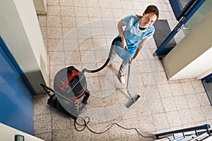 Janitor Vacuuming Floor