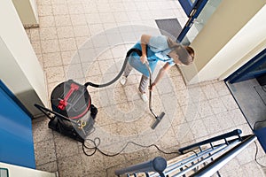 Janitor Vacuuming Floor