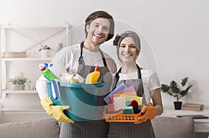 Janitorial Services. Portrait Of Professional Cleaners With Household Supplies In Hands