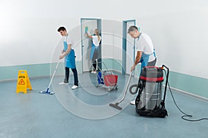 Janitors Cleaning Corridor