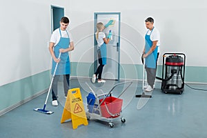 Janitors Cleaning Corridor