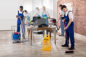 Janitors Cleaning The Office