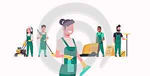 Janitors team cleaning service concept male female cleaners in uniform working together with professional equipment flat