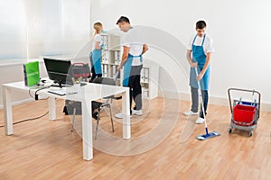 Janitors Together Cleaning Office