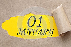january 01. 01th day of the month, calendar date.Hole in paper with edges torn off. Yellow background is visible through