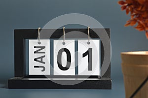 January 01, Date design with a black wooden calendar for a business.