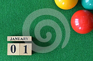 January 01, number cube with balls on snooker table, sport background.