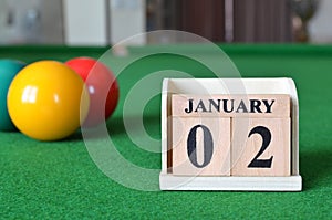 January 02, number cube with balls on snooker table, sport background.