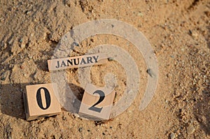 January 02, Number cube with Sand background.