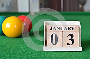 January 03, number cube with balls on snooker table, sport background.