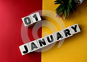 January 1 on wooden cubes on a yellow-red background .