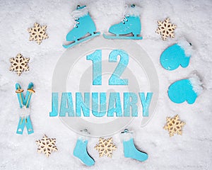January 12th. Sports set with blue wooden skates, skis, sledges and snowflakes and a calendar date. Day 12 of month.