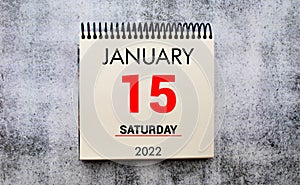 January 15 on a white Notepad .Next to it is a blue clock on a red background.Calendar for January .