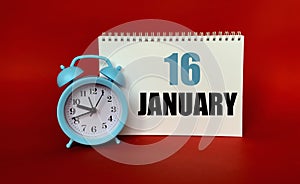 January 16 on a white Notepad .Next to it is a blue clock on a red background.