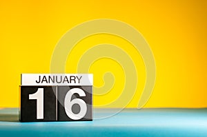 January 16th. Day 16 of january month, calendar on yellow background. Winter time. Empty space for text