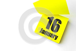 January 16th. Day 16 of month, Calendar date. Close-Up Blank Yellow paper reminder sticky note on White Background. Winter month,