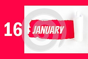 January 16th. Day 16 of month, Calendar date. Red Hole in the white paper with torn sides with calendar date. Winter month, day of