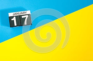 January 17th. Day 17 of january month, calendar on blue and yellow background flat lay, top view. Winter time. Empty