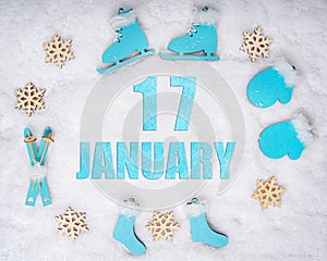 January 17th. Sports set with blue wooden skates, skis, sledges and snowflakes and a calendar date. Day 17 of month.