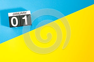 January 1st. Day 1 of january month, calendar on blue and yellow background flat lay, top view. Winter time