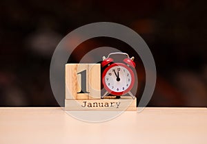 January 1st. Day 1 of January set on wooden calendar with dark background. Winter time