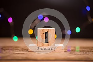 January 1st. Day 1 of January set on wooden calendar with dark background. Winter time. Holiday