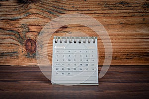 JANUARY 2024 cardboard desk calendar on a wooden texture background