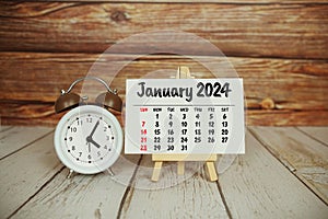 January 2024 monthly calendar on easel stand on wooden background