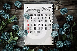 January 2024 monthly calendar with flower bouquet decoration on wooden background