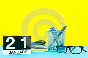 January 21st. Day 21 of january month, calendar on yellow background with office supplies. Winter time