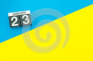 January 23rd. Day 23 of january month, calendar on blue and yellow background flat lay, top view. Winter time. Empty