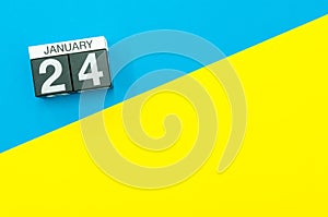 January 24th. Day 24 of january month, calendar on blue and yellow background flat lay, top view. Winter time. Empty